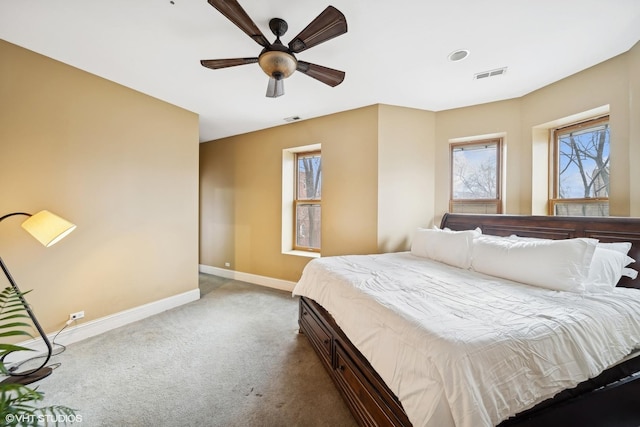 carpeted bedroom featuring visible vents, ceiling fan, and baseboards