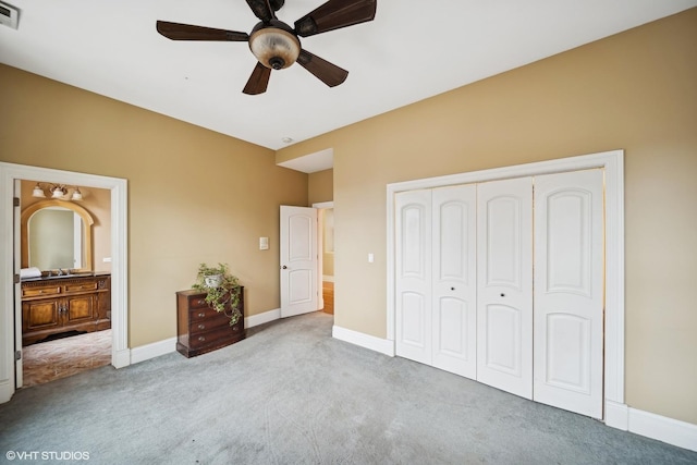 bedroom with light colored carpet, a closet, visible vents, and baseboards