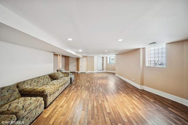 living area with recessed lighting, baseboards, and wood finished floors