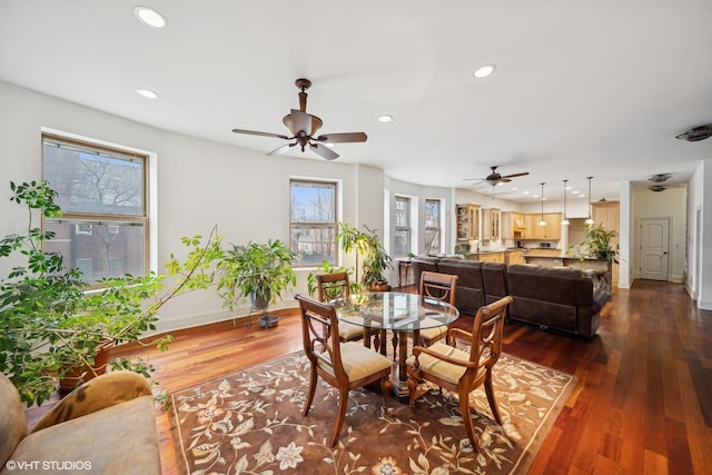 dining space with baseboards, dark wood-type flooring, and recessed lighting