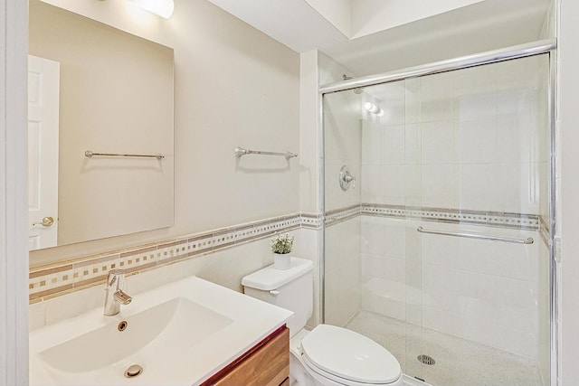 bathroom featuring decorative backsplash, a stall shower, vanity, and toilet