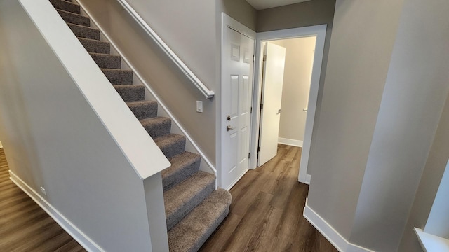 stairs with hardwood / wood-style floors