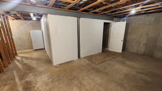 basement with white fridge