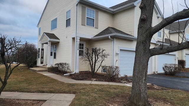 view of front of property with a front lawn and a garage