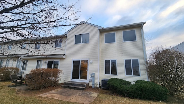 rear view of property featuring a patio area and cooling unit