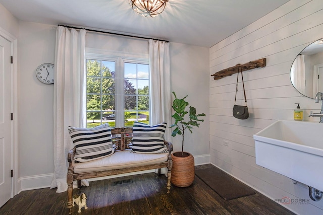 interior space with wooden walls, wood finished floors, and baseboards