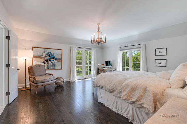 bedroom with access to exterior, multiple windows, an inviting chandelier, and wood finished floors