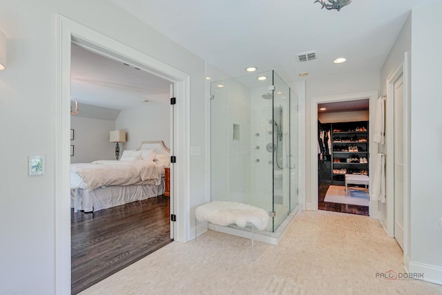 full bathroom featuring a spacious closet, visible vents, a shower stall, connected bathroom, and recessed lighting