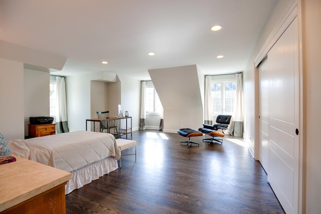 bedroom with dark wood finished floors, recessed lighting, multiple windows, and baseboards