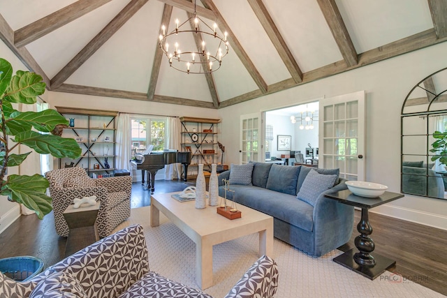 living area featuring an inviting chandelier, wood finished floors, baseboards, and high vaulted ceiling