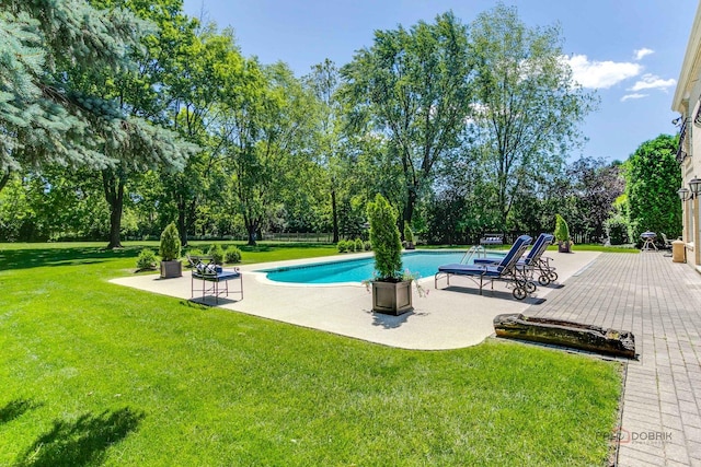 pool with a yard and a patio area