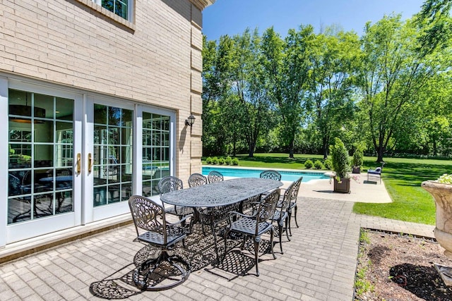 view of patio / terrace featuring outdoor dining space and an outdoor pool