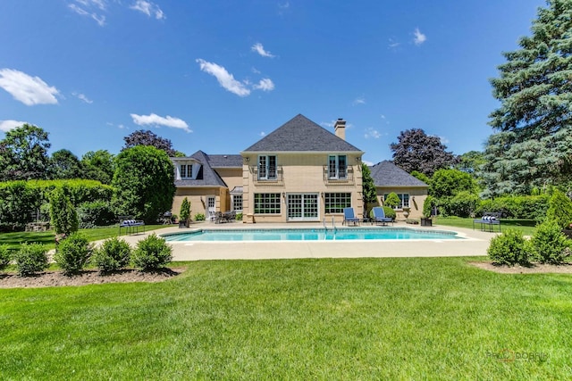 pool featuring a yard and a patio