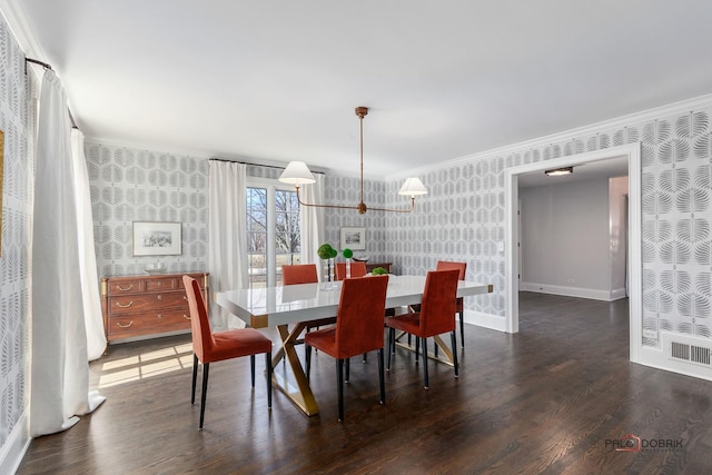 dining area with dark wood-style floors, visible vents, baseboards, wallpapered walls, and ornamental molding