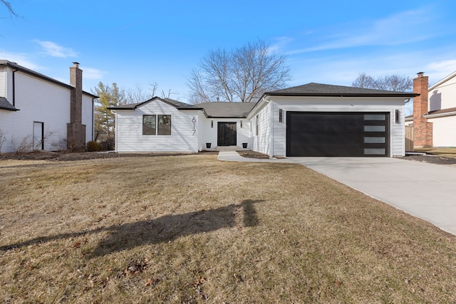 view of front of home with driveway, a front yard, and an attached garage