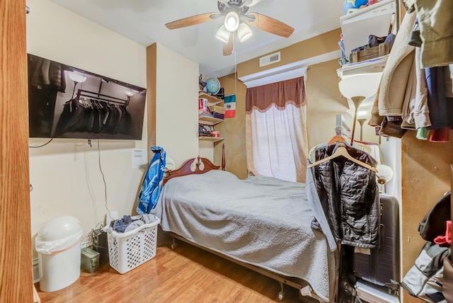 bedroom featuring hardwood / wood-style flooring and ceiling fan