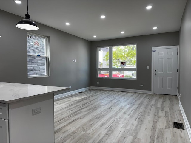 unfurnished dining area with recessed lighting, visible vents, baseboards, and light wood-type flooring