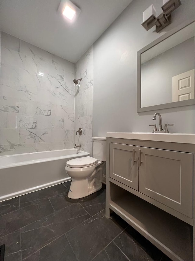 full bathroom featuring tiled shower / bath combo, vanity, and toilet