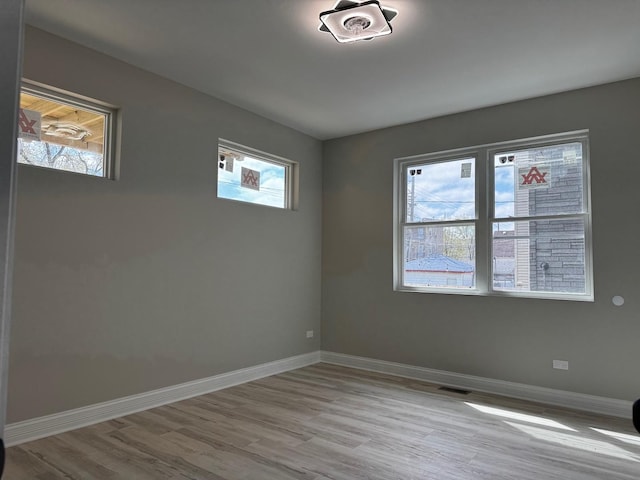 spare room featuring wood finished floors and baseboards