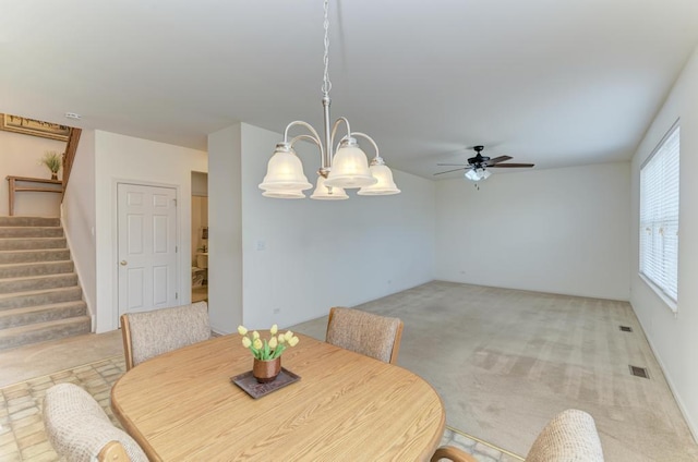 carpeted dining space featuring ceiling fan