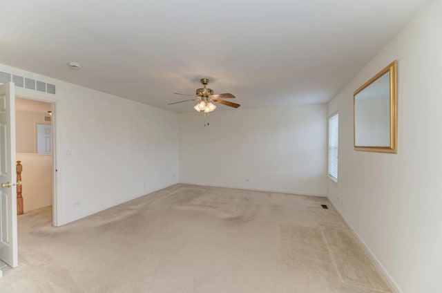 unfurnished room featuring ceiling fan and light colored carpet