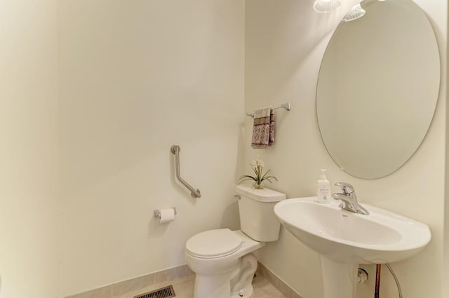 bathroom featuring tile patterned floors and toilet