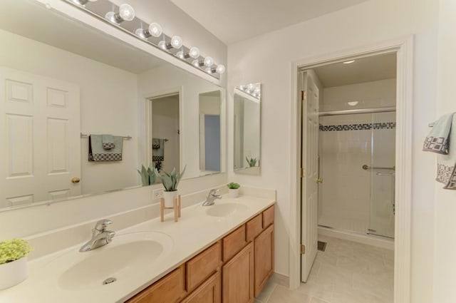 bathroom with tile patterned floors, vanity, and walk in shower