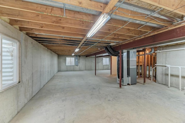 basement with heating unit and electric panel