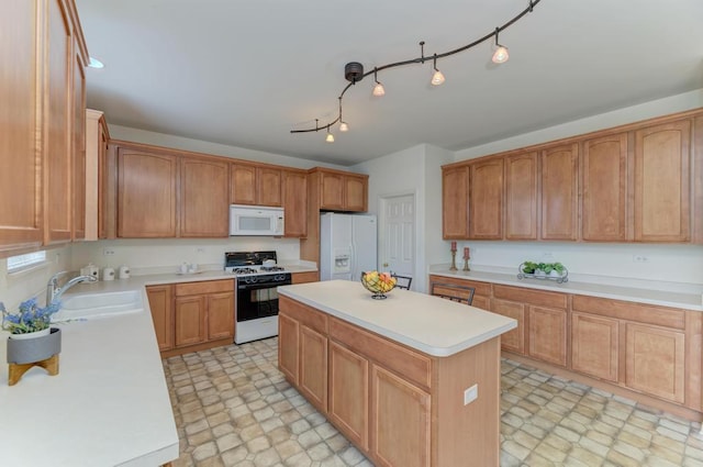 kitchen featuring sink, white appliances, and a kitchen island