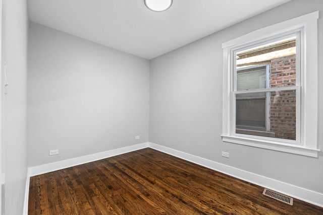 empty room with dark hardwood / wood-style floors