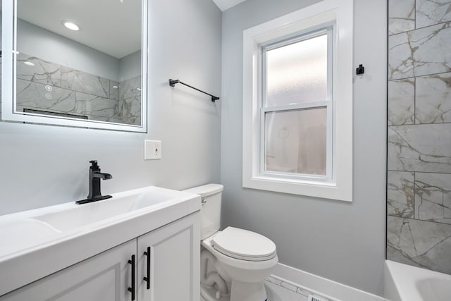 full bathroom featuring toilet, vanity, and tiled shower / bath