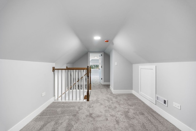 additional living space with light carpet and lofted ceiling