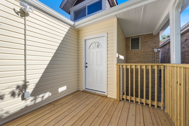 view of exterior entry with a deck