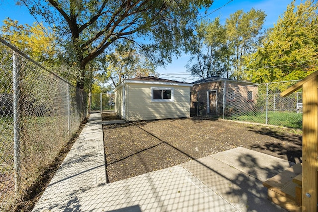 rear view of property featuring an outbuilding