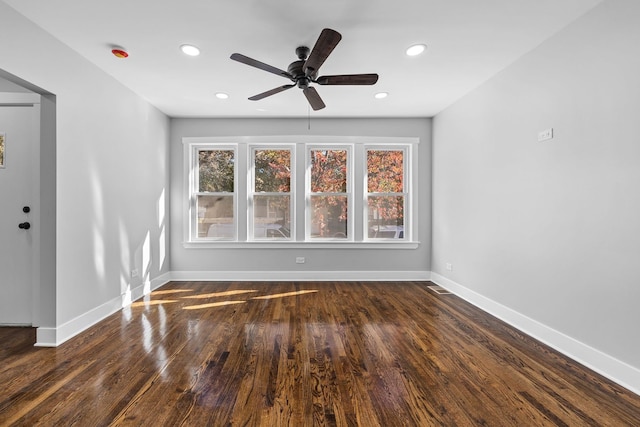 unfurnished room featuring ceiling fan and dark hardwood / wood-style floors