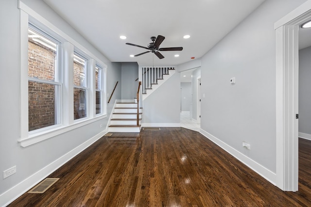 interior space with dark hardwood / wood-style flooring and ceiling fan