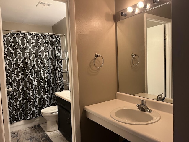 bathroom featuring tile patterned floors, vanity, and toilet