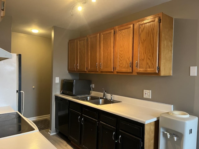 kitchen with sink, black dishwasher, and white fridge