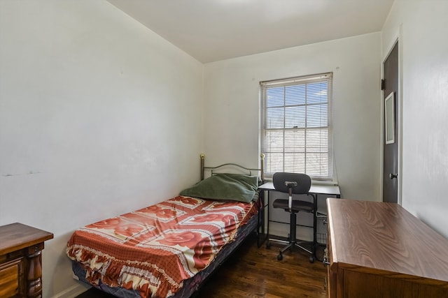 bedroom with dark wood-style floors