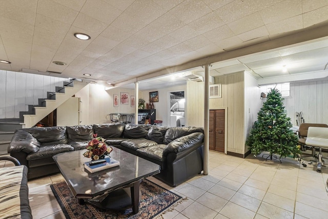 living room with light tile patterned floors, washer / clothes dryer, and stairs