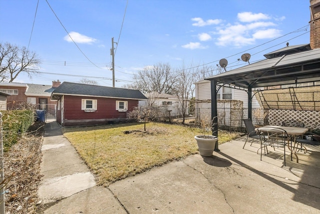 view of yard featuring a gazebo, a patio, outdoor dining space, and fence