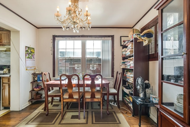 dining room featuring wood finished floors and ornamental molding