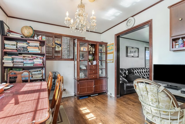 home office featuring a chandelier, baseboards, wood finished floors, and crown molding