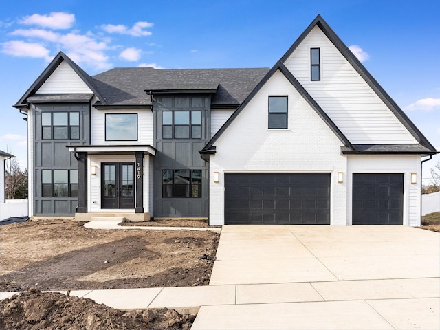 modern farmhouse featuring a garage and french doors