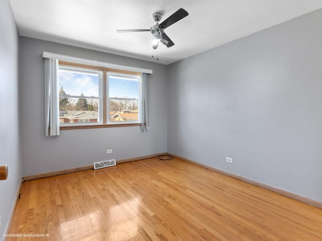 unfurnished room featuring visible vents, baseboards, light wood-style floors, and ceiling fan