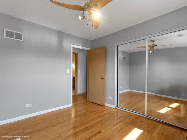 unfurnished bedroom featuring visible vents, baseboards, and wood finished floors