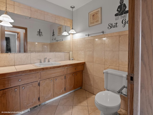 bathroom with toilet, tile walls, and vanity