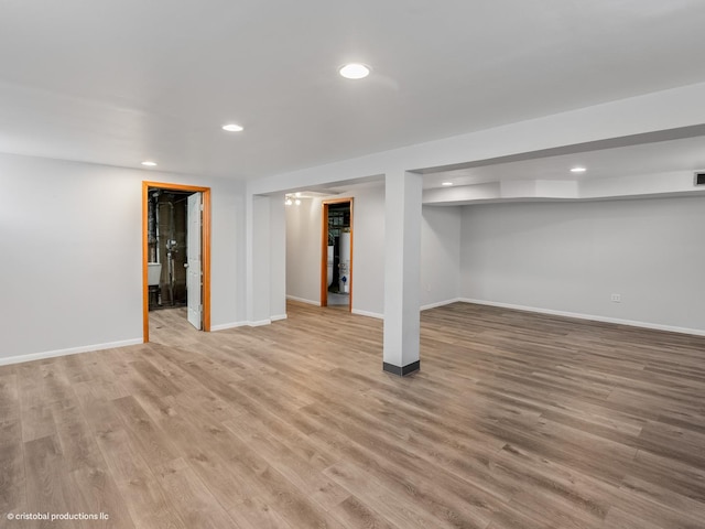 finished basement featuring recessed lighting, visible vents, baseboards, and light wood-style flooring