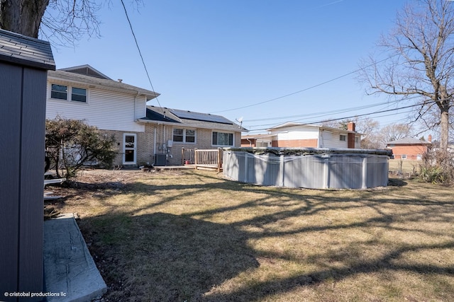 view of yard featuring cooling unit and a fenced in pool