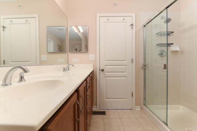 bathroom with vanity, tile patterned flooring, and an enclosed shower